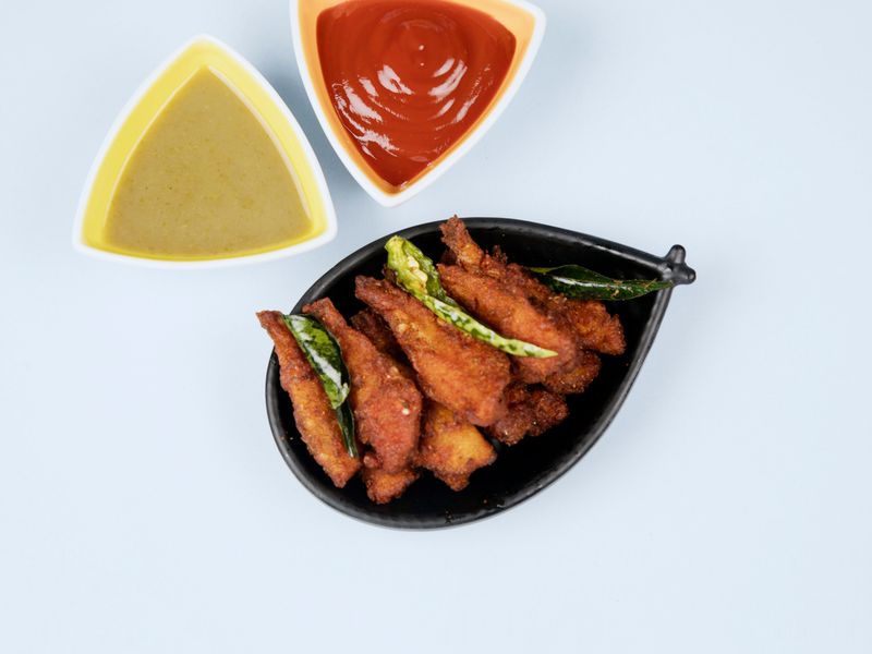 Crispy fried wings being prepared in kitchen
